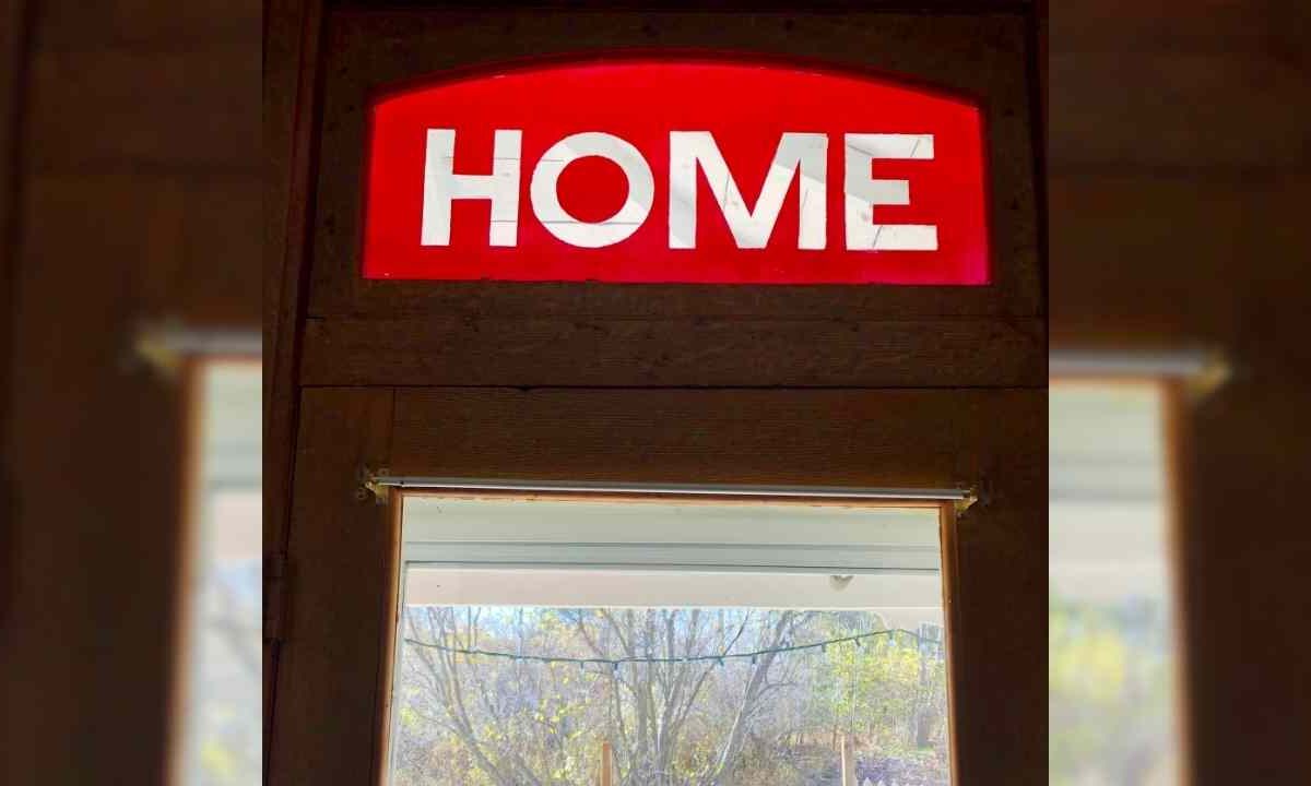 The word "home" hangs over a doorway.