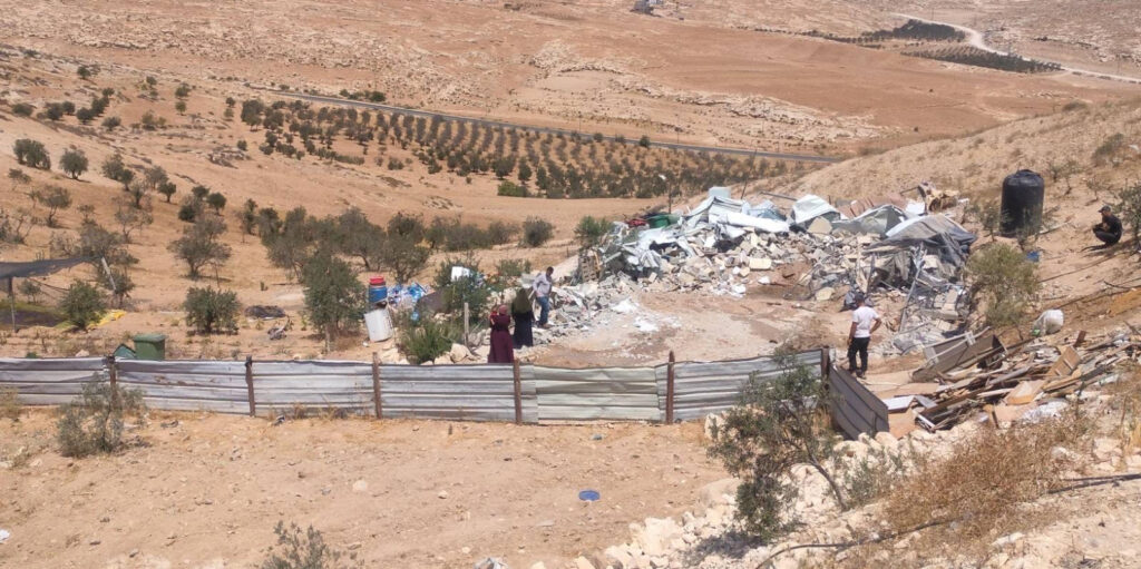 Palestinians sift through the rubble of their homes in the West Bank.