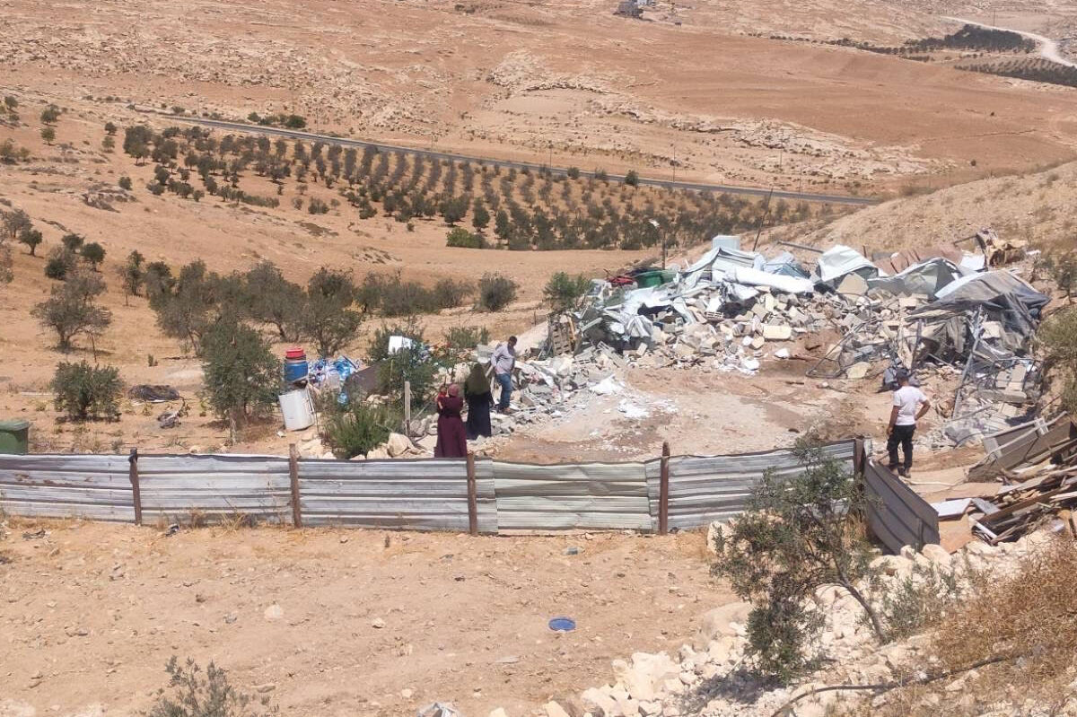 Palestinians sift through the rubble of their homes in the West Bank.