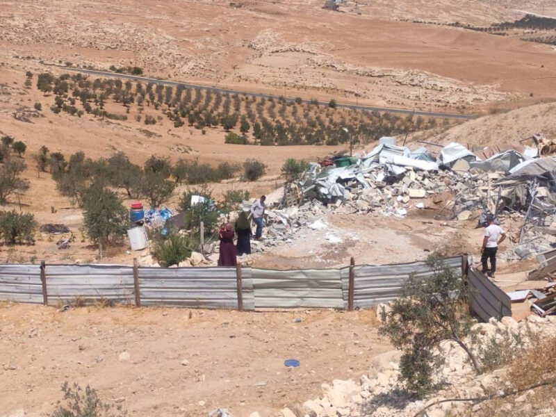 Palestinians sift through the rubble of their homes in the West Bank.