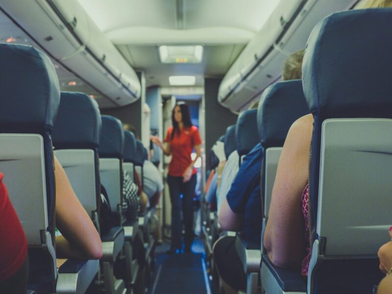 An image of an aisle in a commercial airplane.