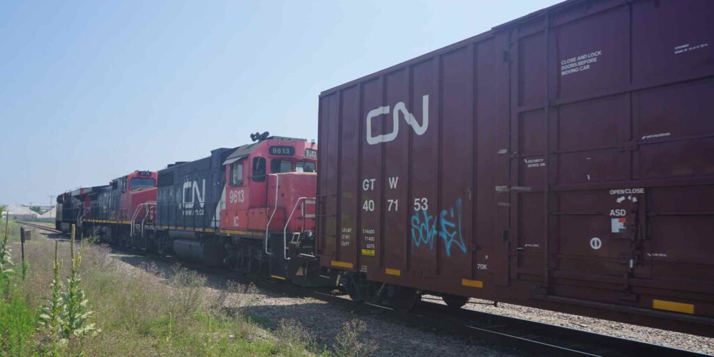 A CN train travelling down tracks.