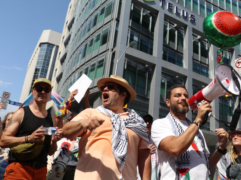 Members of the Palestinian solidarity contingent rally people at the end of the Pride march at Bank Street and Slater. A watermelon balloon hovers in the background.