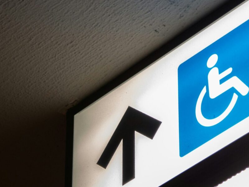 An image of a sign showing direcitons towards a wheelchair accessible ramp. The UFCW says the Canada Disability Benefit needs a boost!