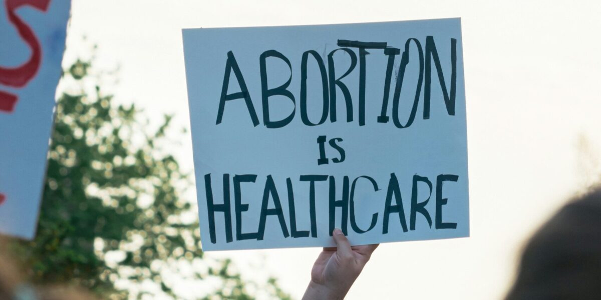 An image from a rally with sign that reads, "Abortion is health care."