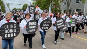 Nurses march through the streets of Charlottetown in June 2023 protesting the understaffing crisis afflicting Canadian public health care.