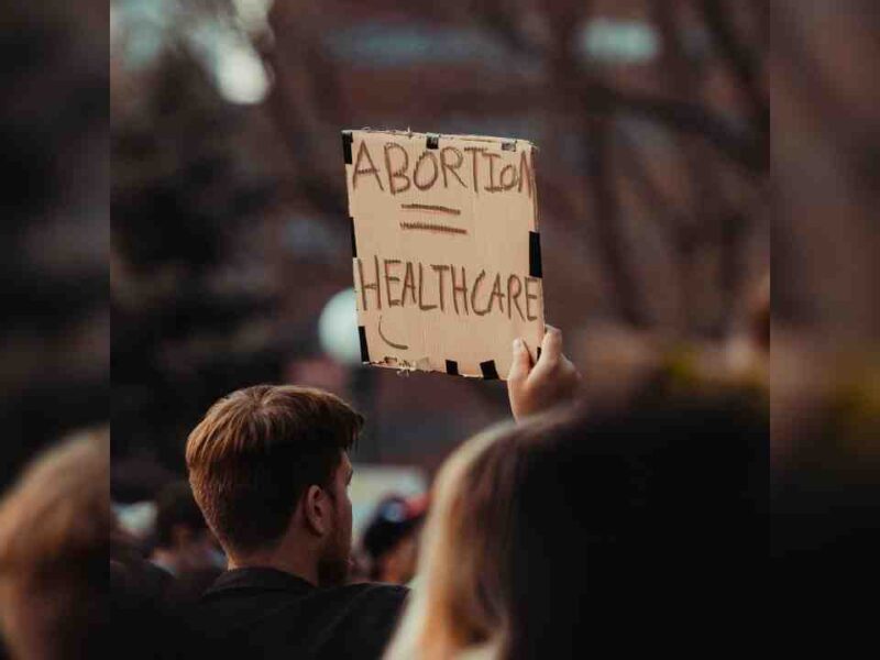 A person holding a sign that reads abortion = healthcare.