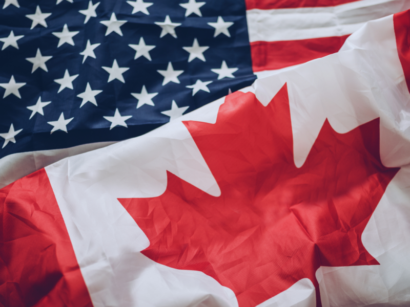 A Canadian flag and U.S. flag.