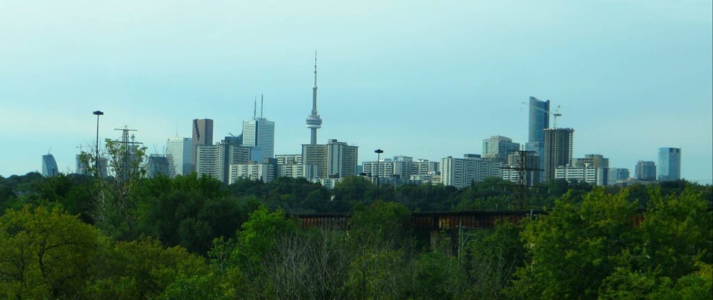 The greenery of the Don Valley Parkway in front of Toronto's skyline.