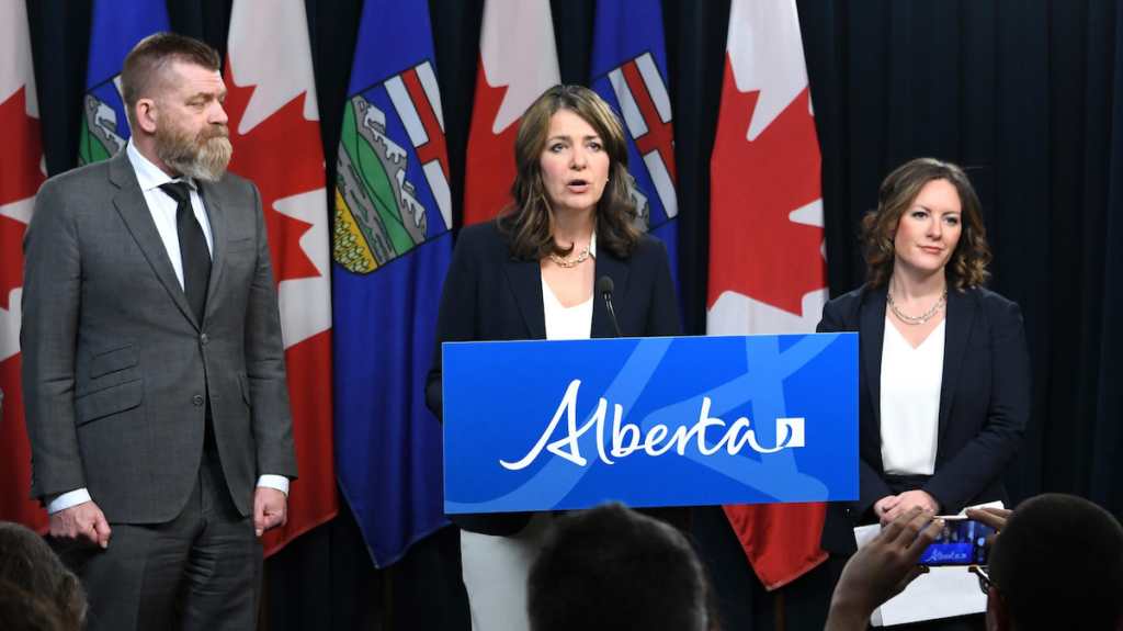 Alberta Premier Danielle Smith, flanked by Energy Minister Brian Jean and Environment Minister Rebecca Schulz at a press conference.