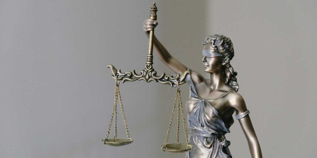 Blind lady justice holding scales.