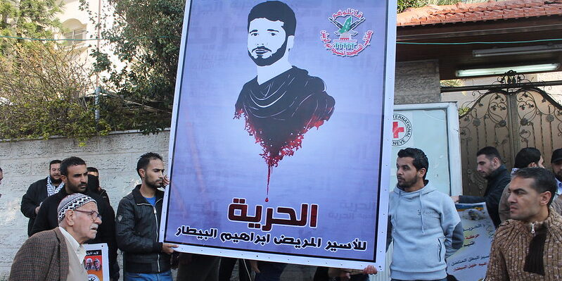 A rally taking place outside the Red Cross' office in Gaza the same day that three former Palestinian prisoners were released into the Gaza Strip.