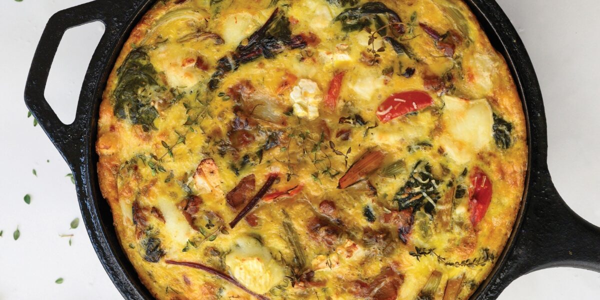 An image of a frittata in a pan. This recipe by Harrowsmith, dubbed the free-ttata, makes use of leftover veggies lurking in the fridge.