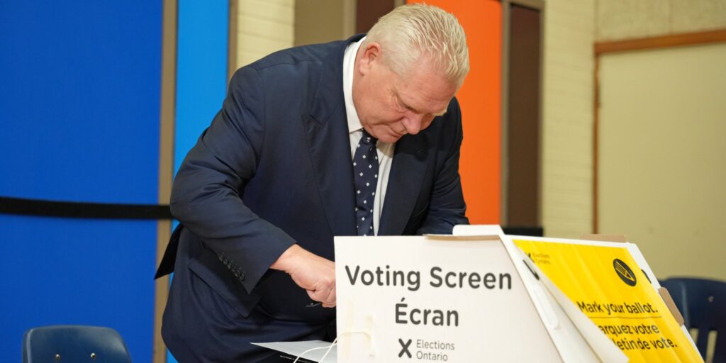 Progressive Conservative leader Doug Ford considers his options behind the voting screen on February 27, 2025.