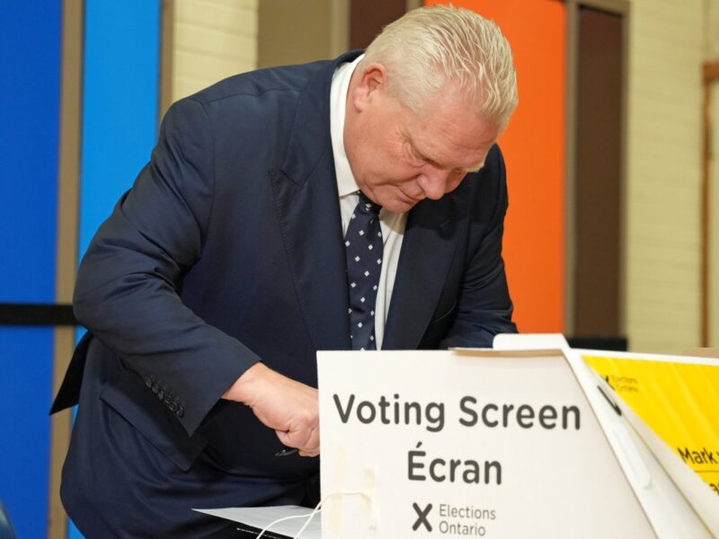 Progressive Conservative leader Doug Ford considers his options behind the voting screen on February 27, 2025.