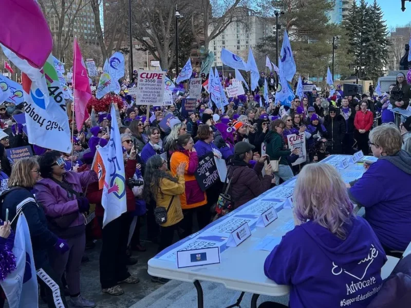 Striking CUPE members clad in purple set up a bargaining table at the foot of the steps of the Legislature and challenge the government to come out and negotiate during yesterday’s reading of the Budget Speech.