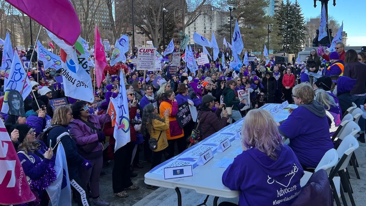 Striking CUPE members clad in purple set up a bargaining table at the foot of the steps of the Legislature and challenge the government to come out and negotiate during yesterday’s reading of the Budget Speech.