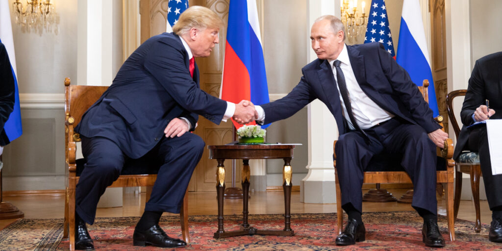 Donald Trump shaking hands with Vladimir Putin in 2018.