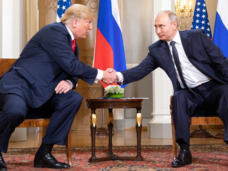 Donald Trump shaking hands with Vladimir Putin in 2018.