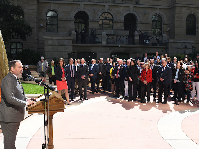 Former Alberta Premier Jason Kenney before a still-veiled statue of Winston Churchill in Calgary in June 2024.