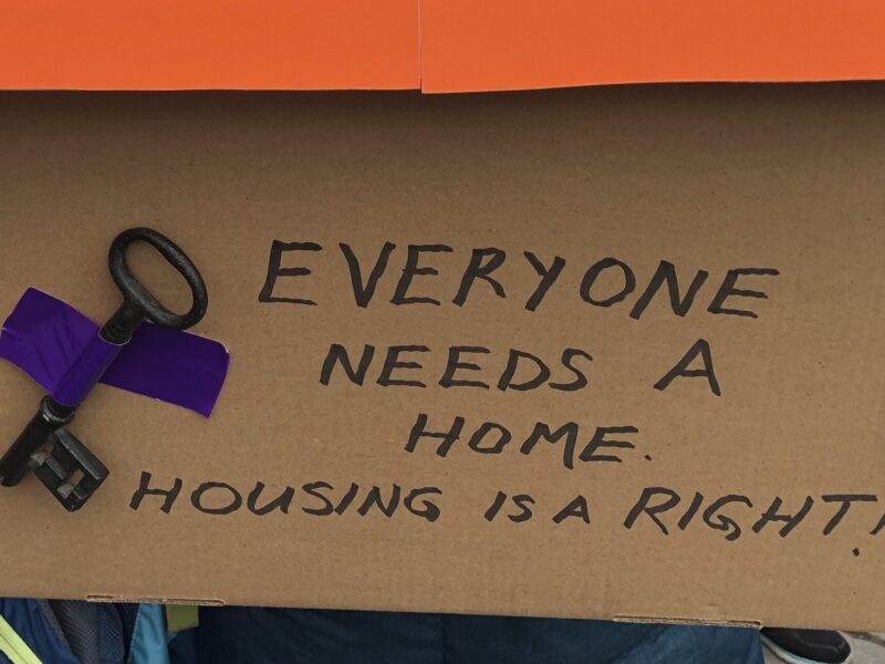 A sign advocating for the rights of the unhoused.