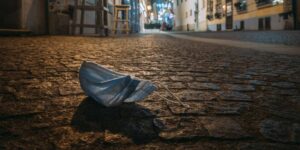 A facemask discarded on the ground.