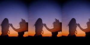 A couple of women dancing in a field.