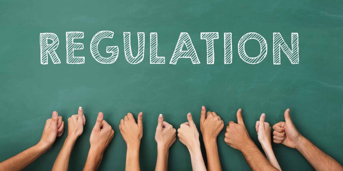 Eight arms giving thumbs up to the word "Regulation" written on a chalk board.
