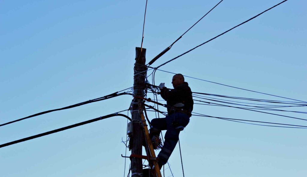 An electrician working on power lines.