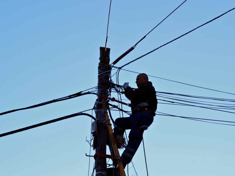 An electrician working on power lines.