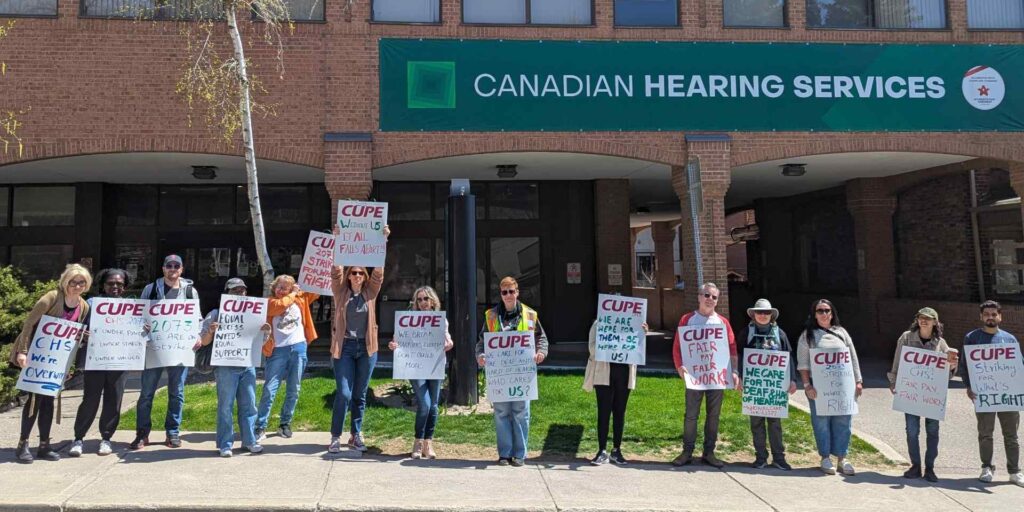 Members of CUPE 2073 striking outside of the Canadian Hearing Service offices.