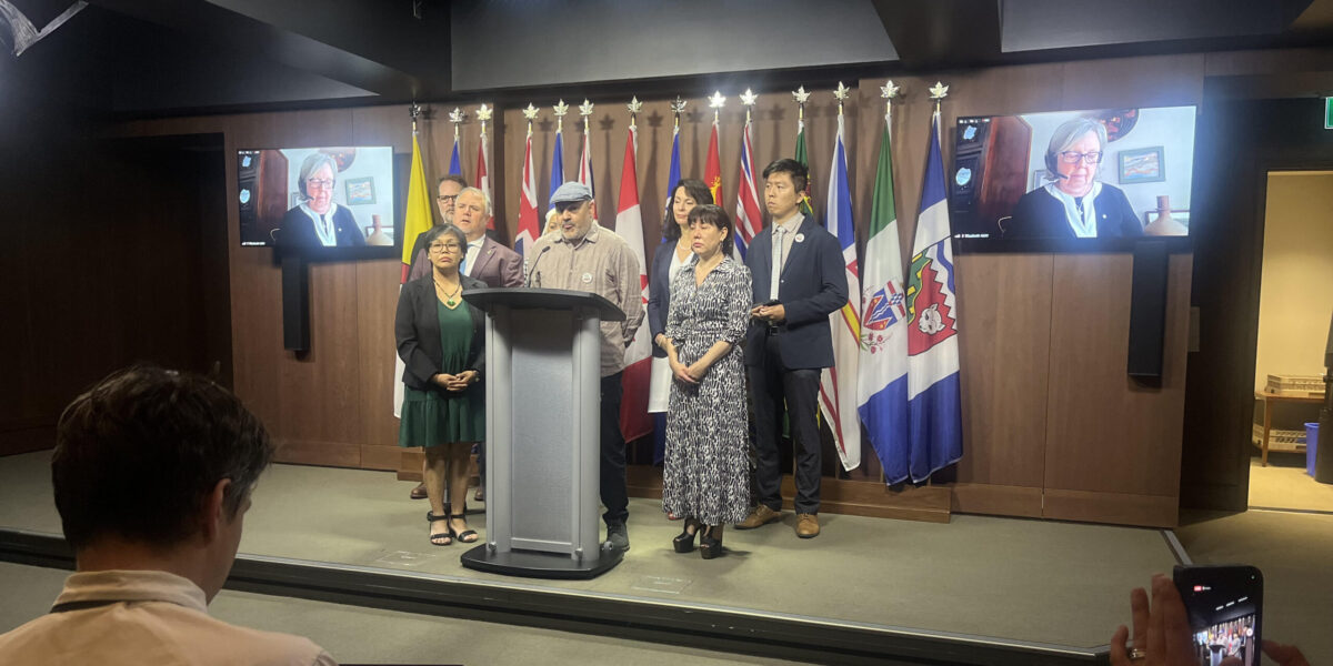 Manuel Tapial of Palestine Vivra addresses the press conference as MPs and supporters look on.