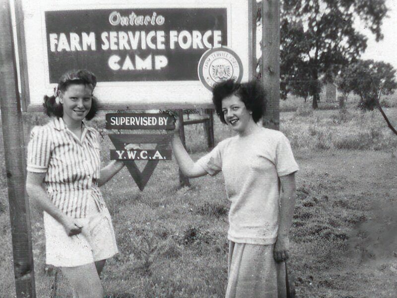 An image of two Farmerettes outside the Ontario Farm Service Force camp.