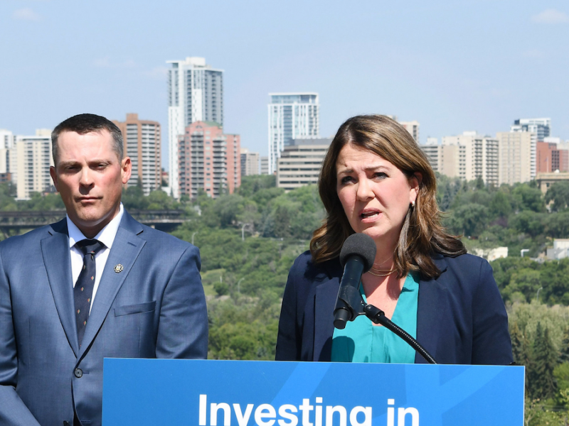 Alberta Premier Danielle Smith, with Finance Minister Nate Horner looking on, during Friday’s news conference in Edmonton.