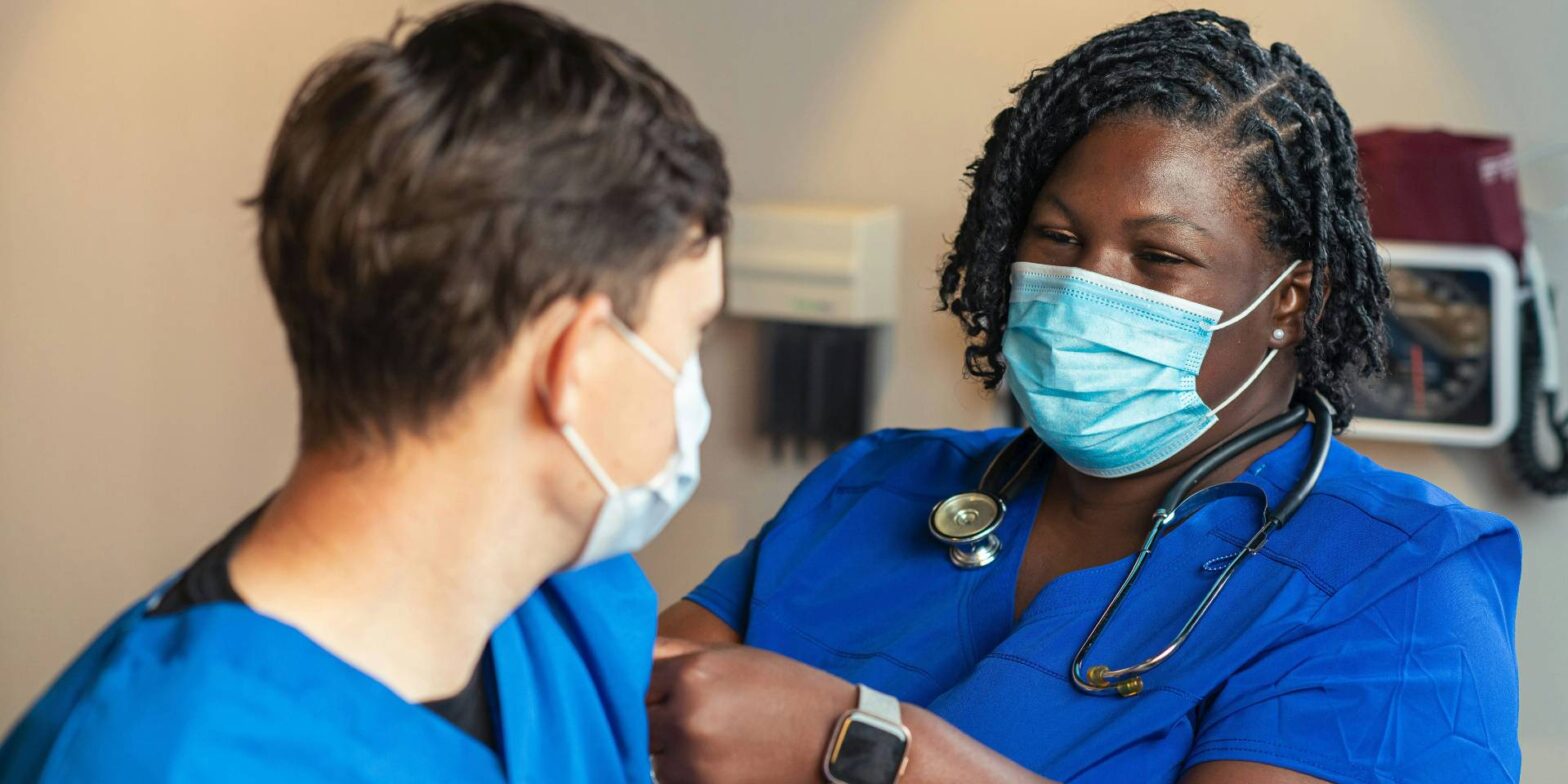 A nurse caring for a patient.