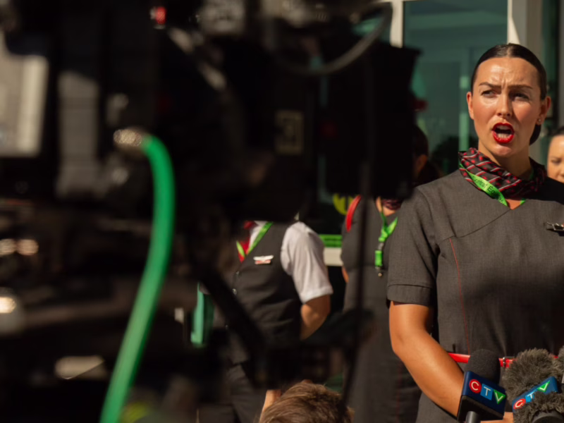 An image of Henly Larden, flight attendant and VP of the union local of CUPE 4904, speaking to the media. Larden thanked airline passengers for their solidarity during the recent strike.