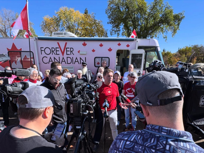 Thomas Lukaszuk, in red t-shirt, at Friday’s Edmonton news conference.