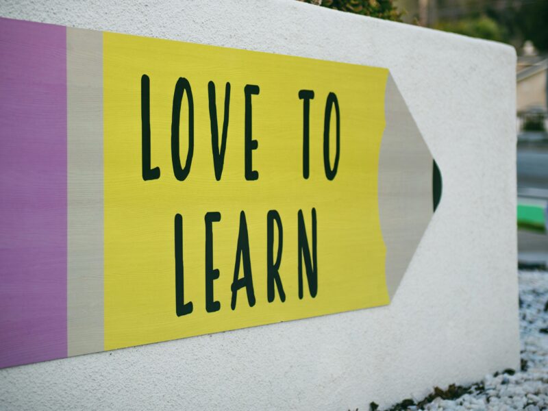 An image of a sign on a schoolyard that reads, "Love to learn." CUPE’s education sector is cautiously welcoming Quebec’s decision to remove the caps on full-time equivalent positions.