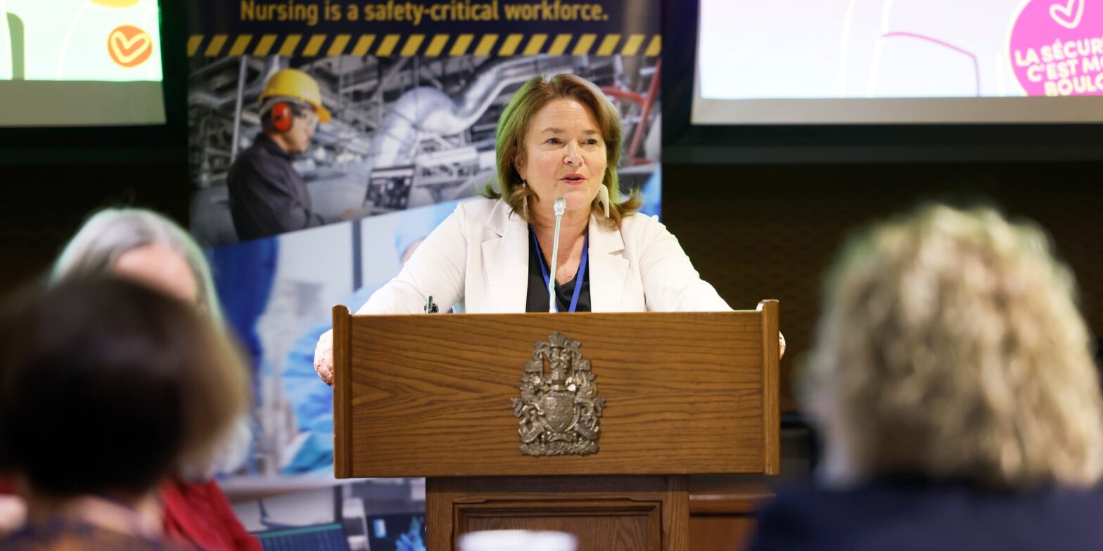 An image of CFNU president speaking inside Parliament Hill. CFNU warns that Budget 2025 doesn't do enough to address healthcare staffing issues.