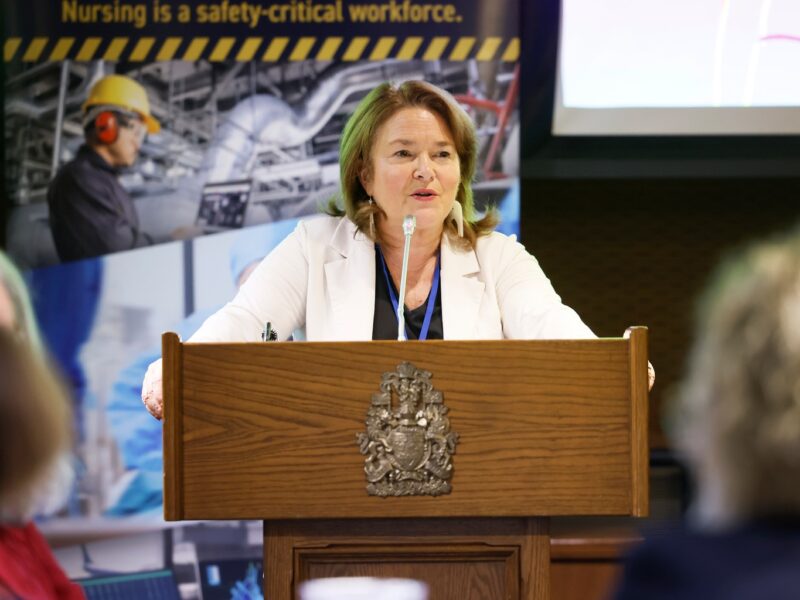 An image of CFNU president speaking inside Parliament Hill. CFNU warns that Budget 2025 doesn't do enough to address healthcare staffing issues.