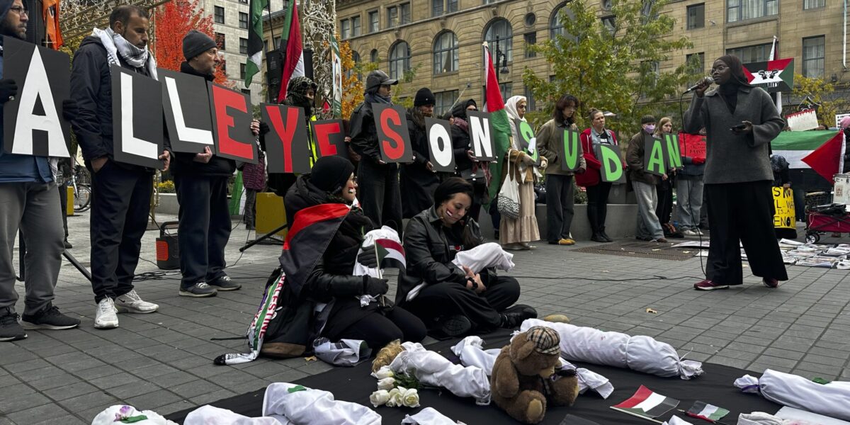 Demonstrators hold placards reading "All Eyes on Sudan" in Montréal's Square Phillips.