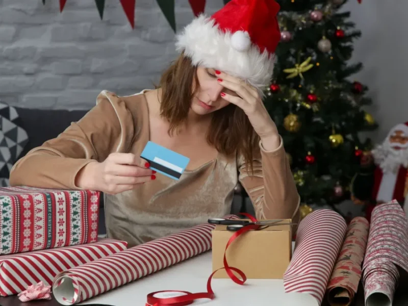 A woman stressed over the cost of the holiday season.