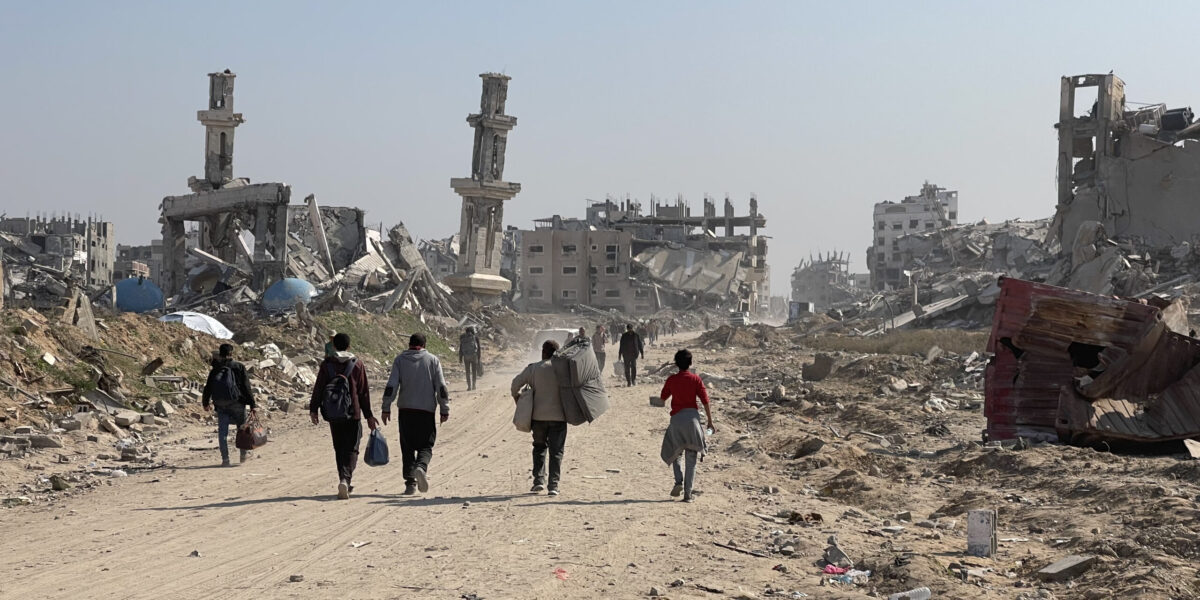 Palestinians walking through the rubble of Gaza on January 29. 2025.