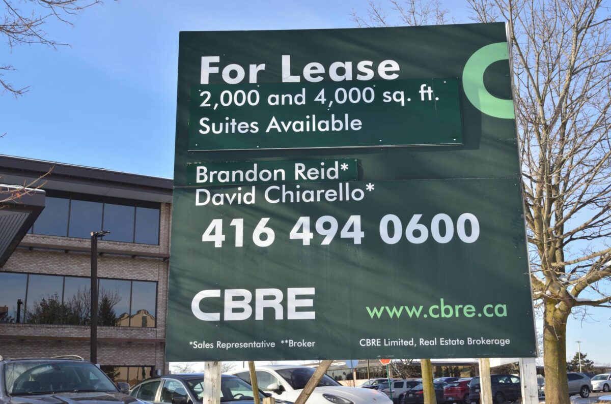 A sign advertising a commercial space for lease.