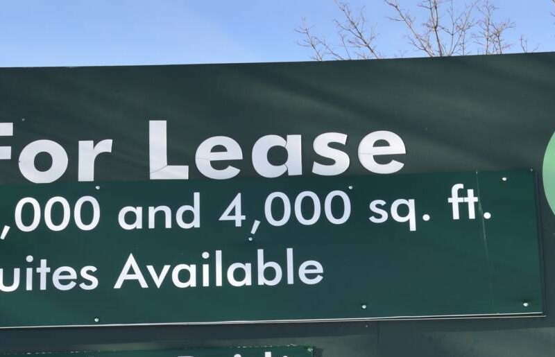 A sign advertising a commercial space for lease.