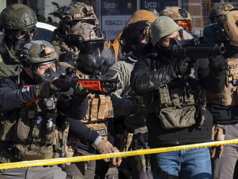 ICE officers pointing weapons at civilians in Minnesota after the shooting of Alex Pretti.