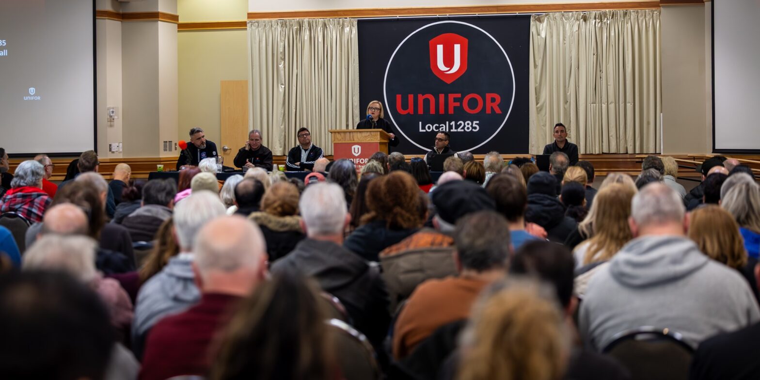 An image of Lana Payne, president of Unifor, addressing the crowd at a meeting of Unifor Local 1285. The Stellantis Brampton assembly plant that employs many of this local's members just secured protection through auto assembly zoning.