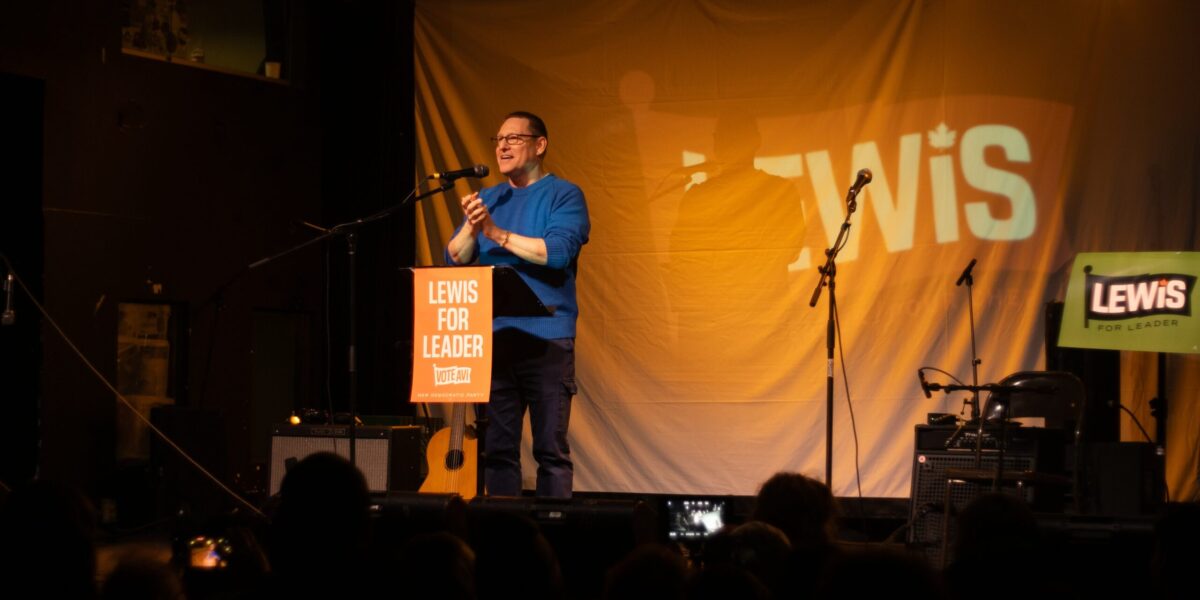 Avi Lewis speaking at an event.