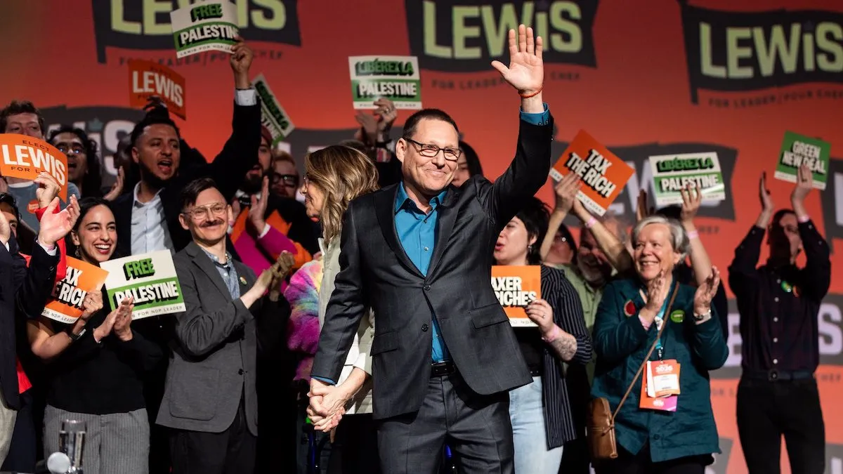 Federal New Democratic Party Leader Avi Lewis, holding the hand of his wife Naomi Klein, celebrates his victory at the NDP national convention in Winnipeg.