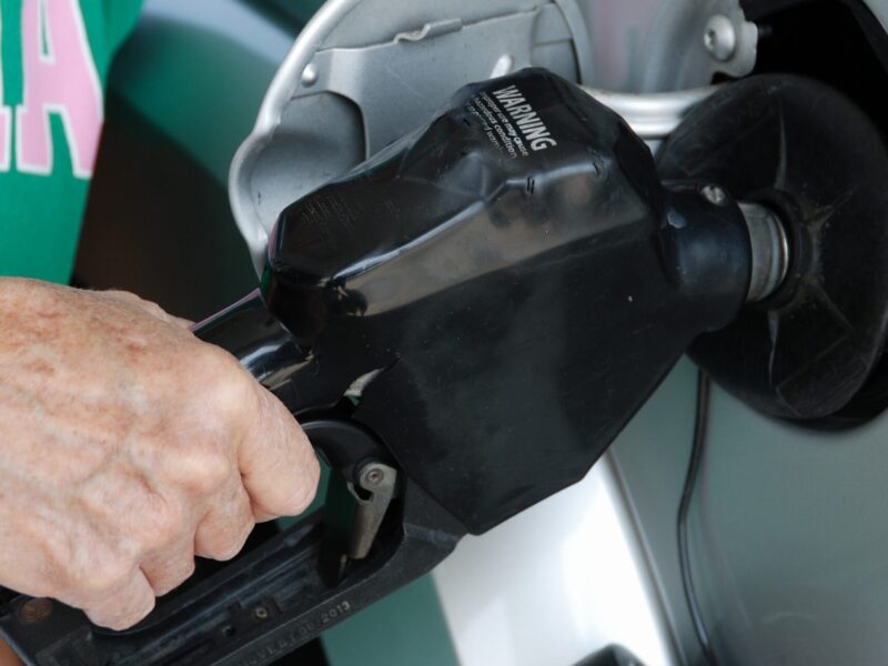 A person pumping gas.